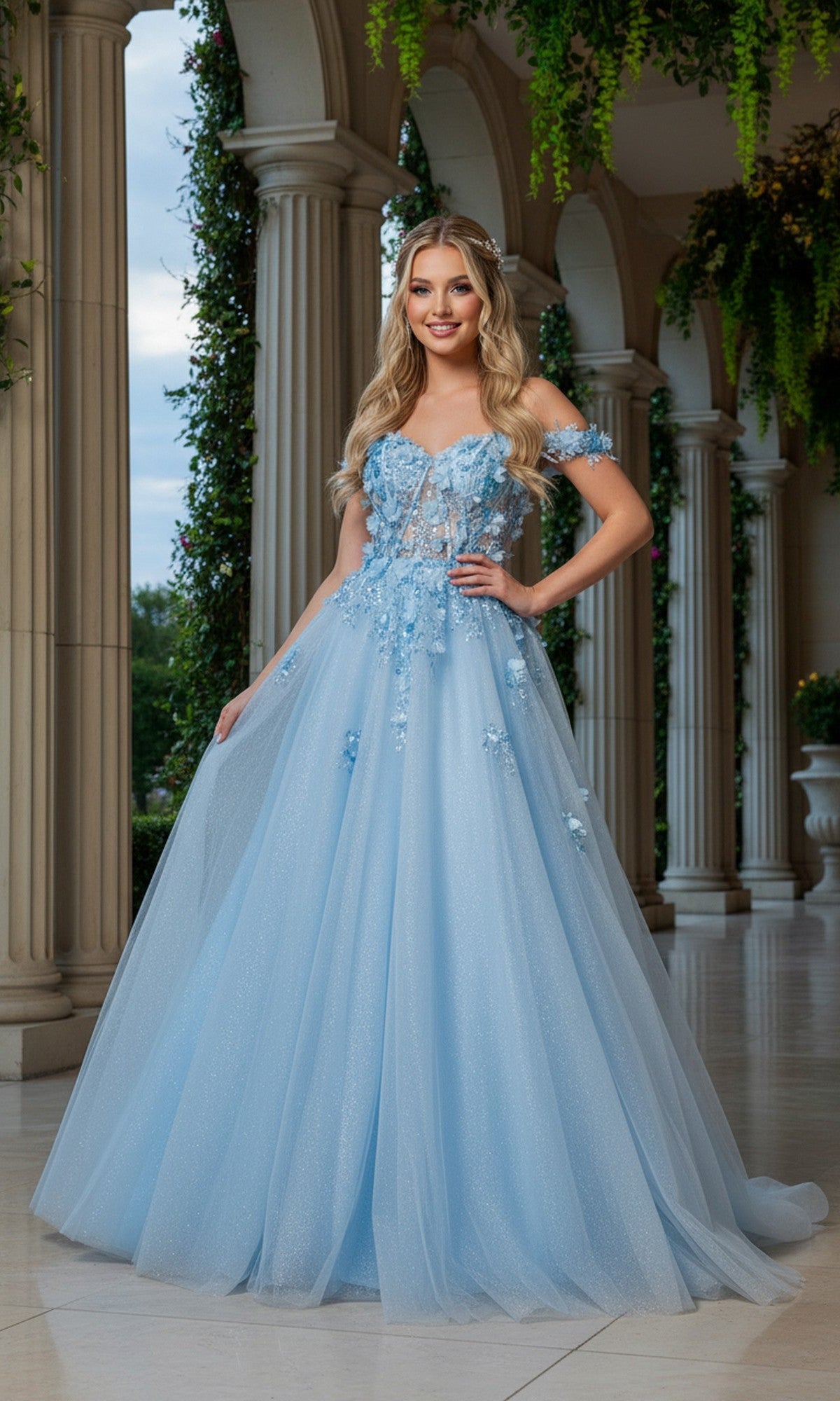 A woman in the blue Long Prom Dress: Cinderella Couture 8403J smiles at the camera, standing before tall columns and greenery.